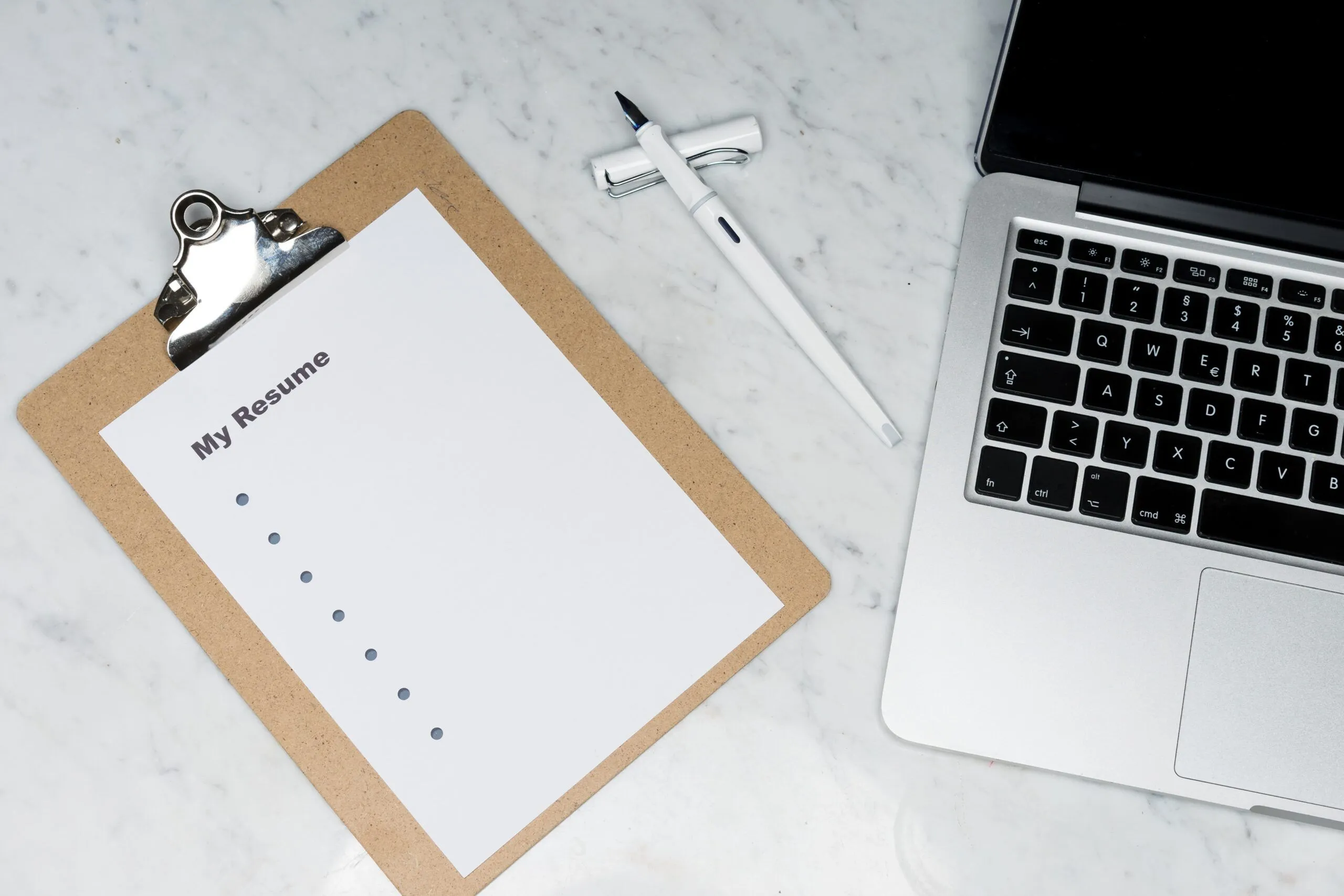 markus-winkler-7iSEHWsxPLw-unsplash Man writing on a white paper during a meeting